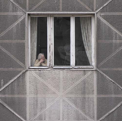 one older person looking out of a window